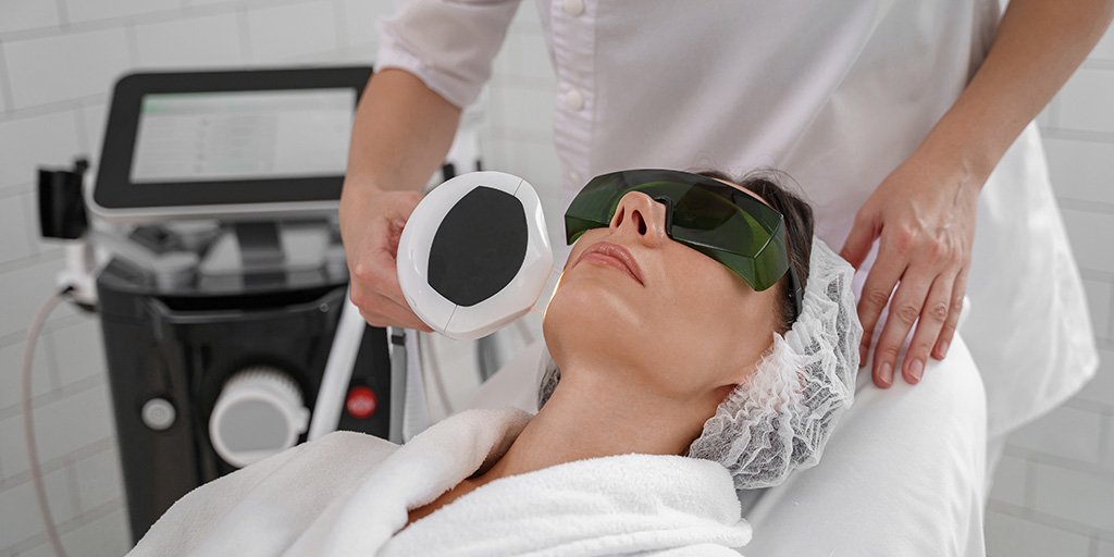 woman getting facial laser treatment